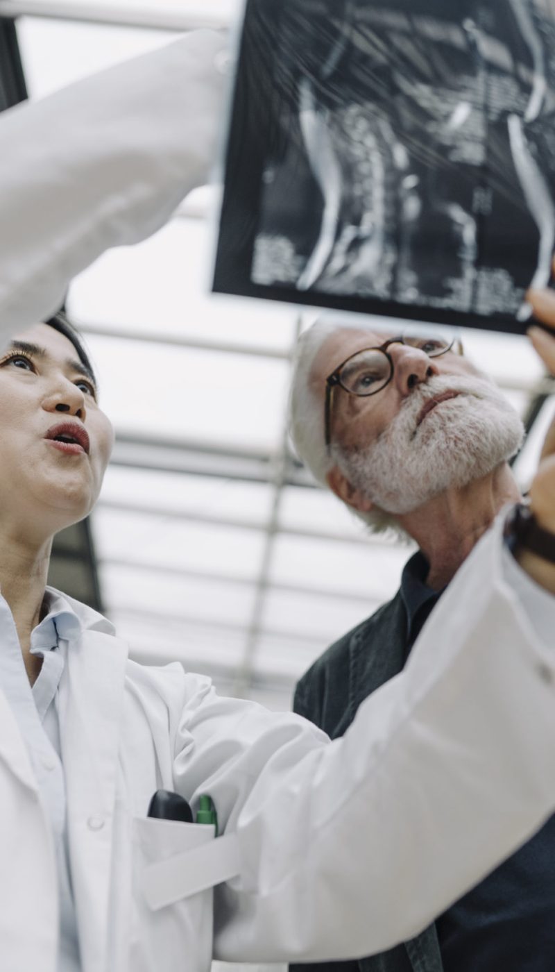Female doctor discussing x-ray with senior patient